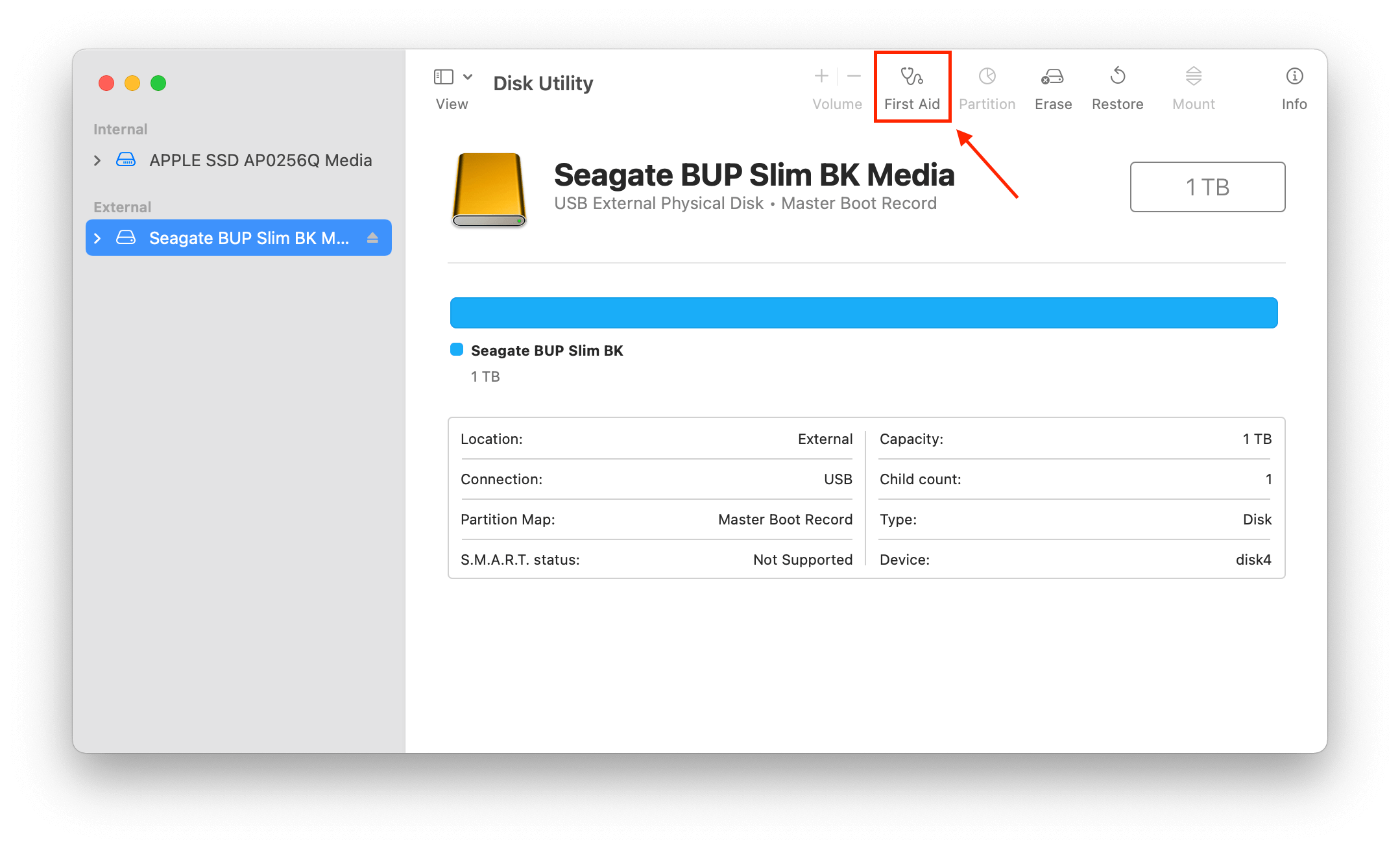 Disk Utility window showing a pointer towards the First Aid option